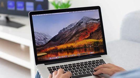 Customer checking MacBook Pro condition before purchase at PayMore Abilene